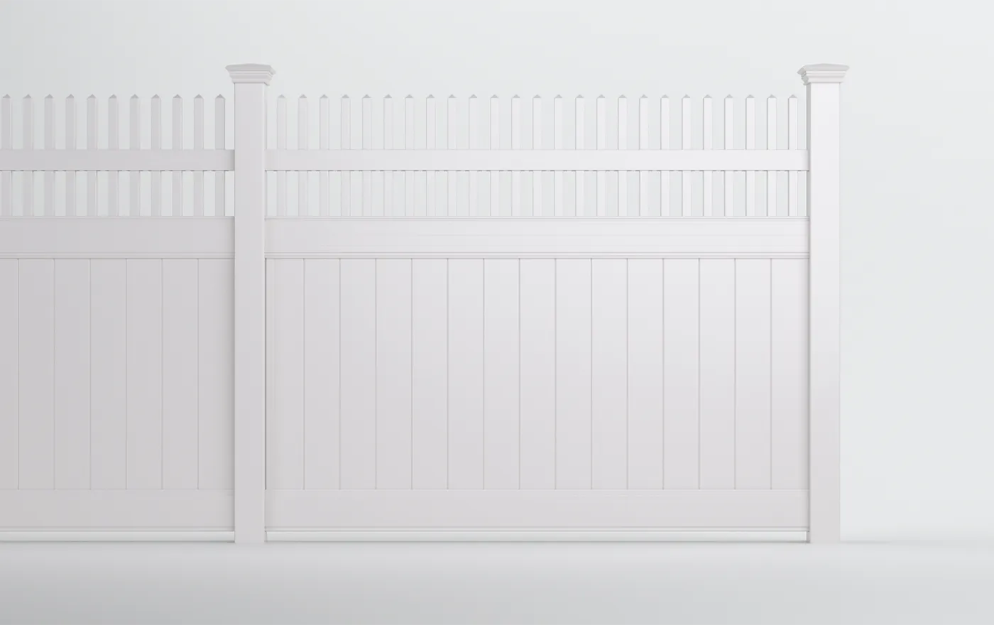 White picket fence with a solid bottom panel and decorative cutout top edge, set against a plain gray background. The fence is clean and well-maintained, with vertical slats and two visible posts.