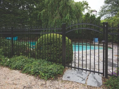 black aluminum spear top picket fence with gate surrounding pool