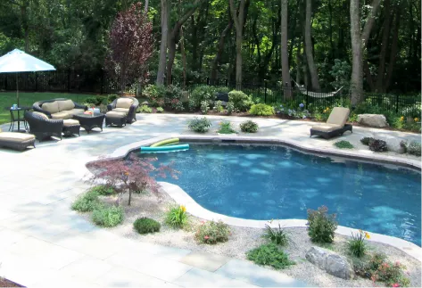 backyard pool area surrounded by black aluminum picket fence