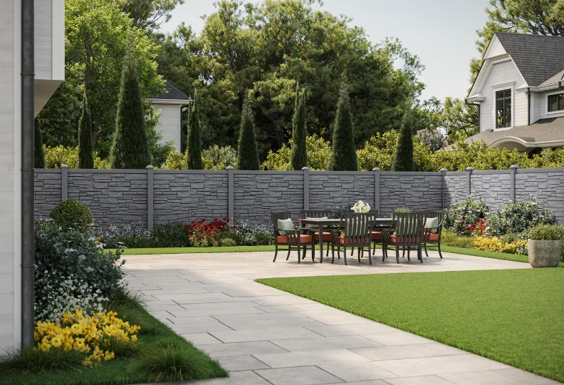 outdoor dining area with pavers and molded privacy fence